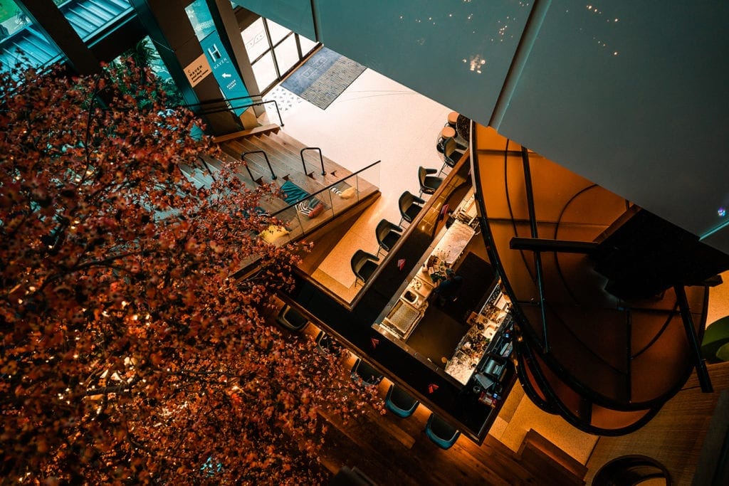 A stunning bird's-eye view of the bar at the Lake Nona Wave Hotel wedding venue, showcasing the hotel's contemporary interior design and trendy decor.