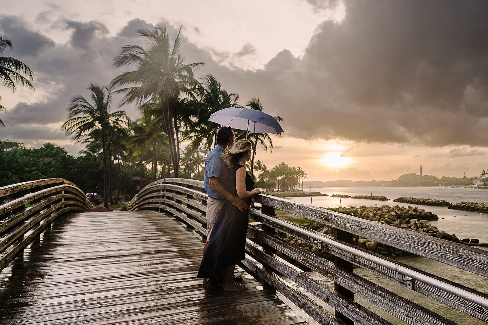 A couple enjoys their destination honeymoon in Bora Bora while watching the sunset.