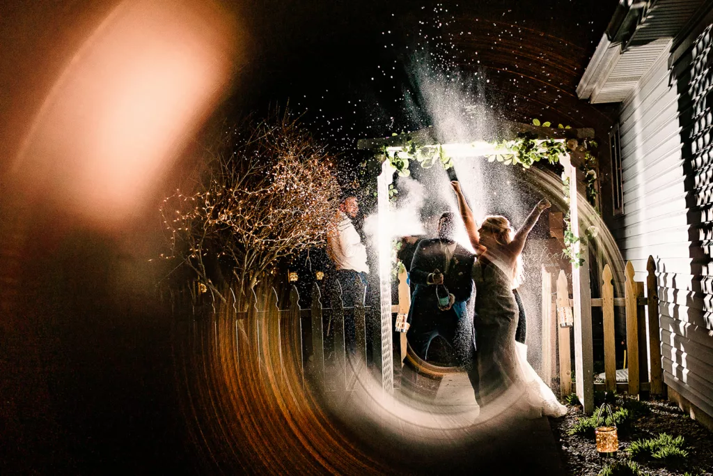 Couple happily spraying champagne at their wedding celebration