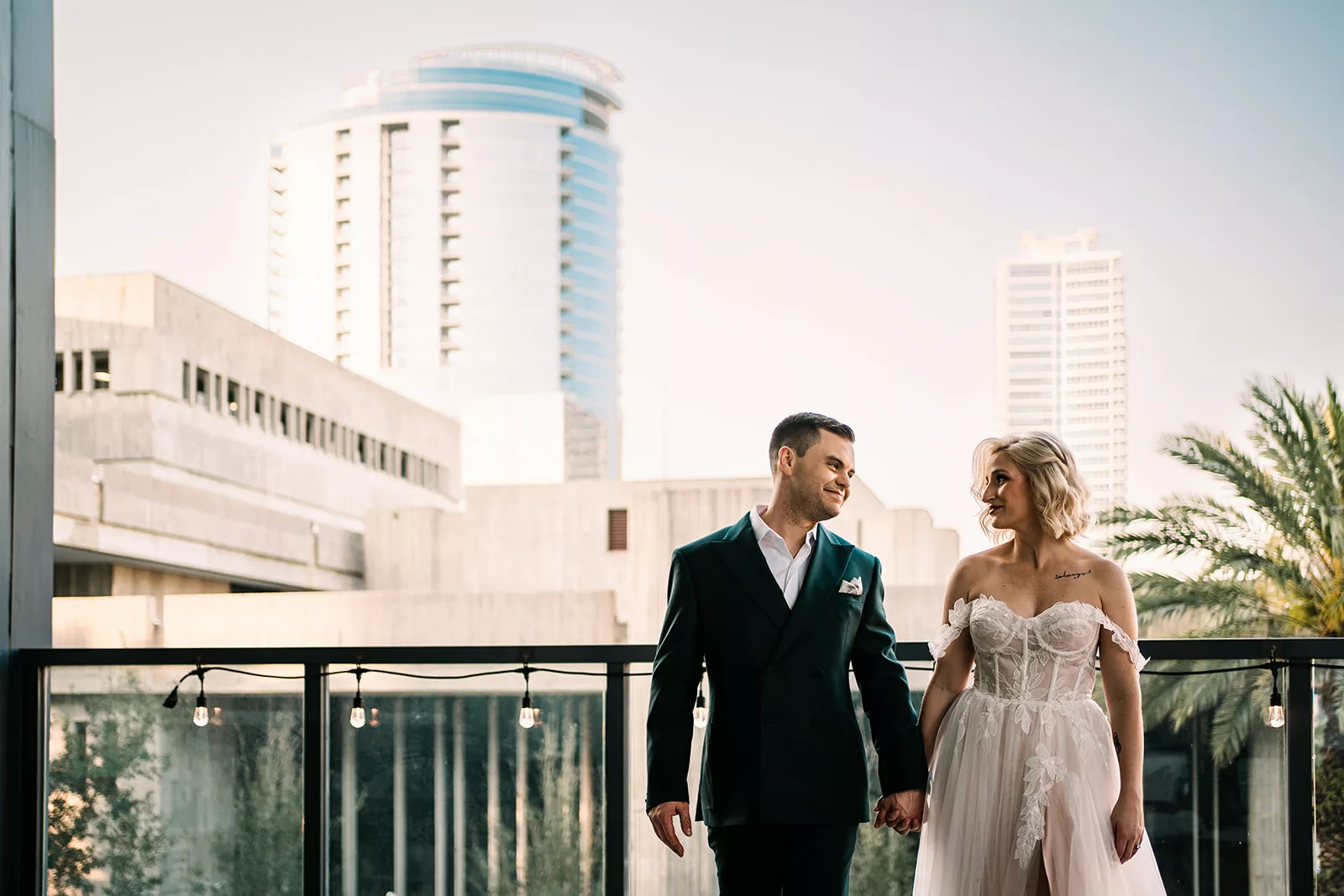 Happy couple taking in the stunning skyline from the rooftop of their University Club Orlando wedding venue